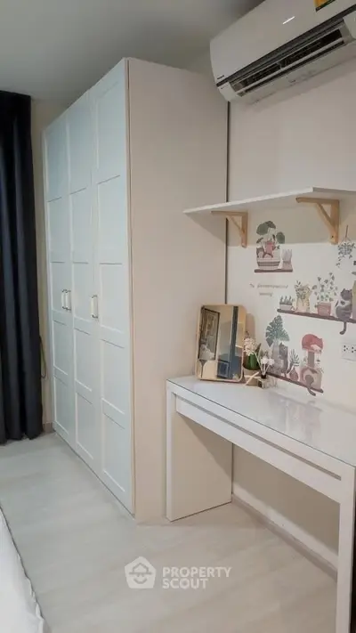 Charming bedroom with stylish wardrobe and cozy study nook