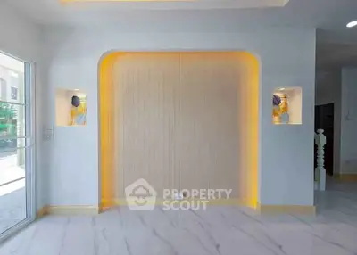 Modern interior with elegant lighting and stylish wall niches in a bright living space.