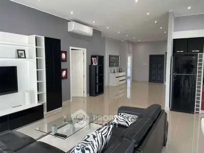 Modern living room with sleek black and white decor, featuring a spacious layout and stylish furnishings.