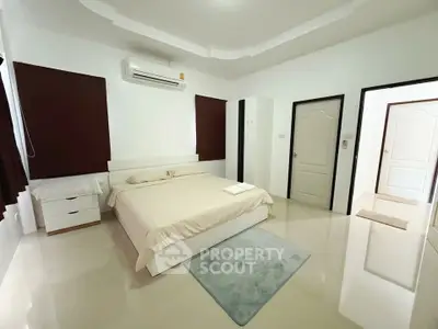 Spacious modern bedroom with sleek design and neutral tones