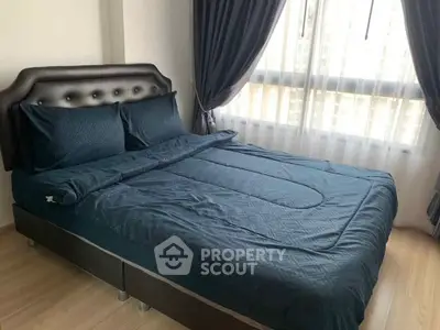 Cozy bedroom with elegant dark bedding and large window with curtains