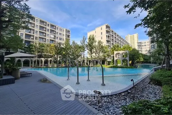 Luxurious residential complex with a stunning pool and lush greenery, perfect for relaxation and leisure.