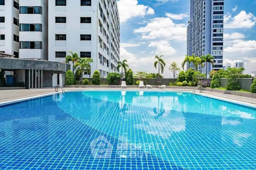 Luxurious high-rise apartment with stunning pool and city views, perfect for urban living.