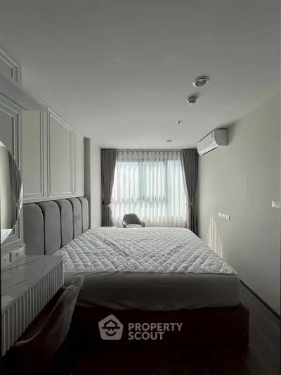 Modern bedroom with stylish decor and natural light, featuring a comfortable bed and elegant curtains.