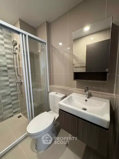 Modern bathroom with sleek fixtures and glass shower enclosure