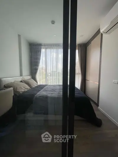 Modern bedroom with large window and stylish decor