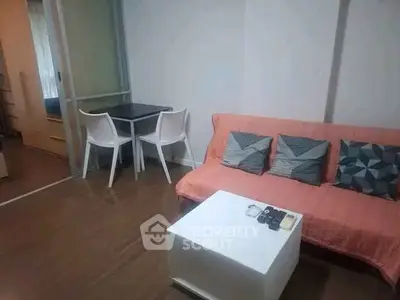 Cozy living room with modern decor and dining area in compact apartment.
