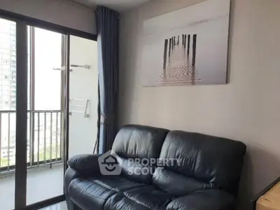 Cozy living room with leather sofa and balcony view in modern apartment