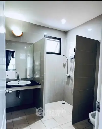 Modern bathroom with sleek design and walk-in shower in a contemporary home.