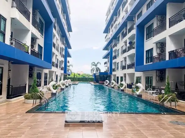 Luxurious apartment complex with a stunning central swimming pool and modern architecture.