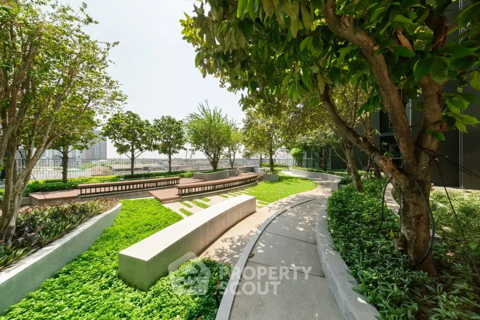 Lush green rooftop garden with city views and seating areas