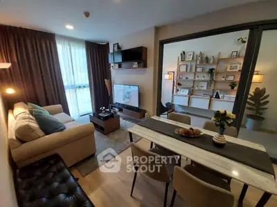 Modern living room with cozy seating and stylish decor, featuring a dining area and open shelving.