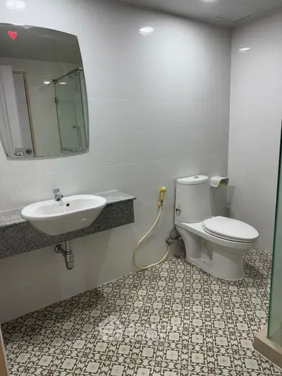 Modern bathroom with stylish patterned floor tiles and sleek fixtures.