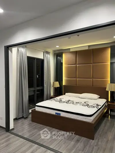 Modern bedroom with stylish decor and large windows in a contemporary apartment.