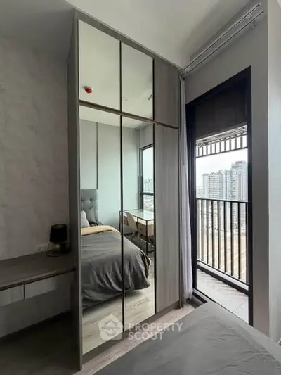 Modern bedroom with mirrored wardrobe and balcony view in urban apartment