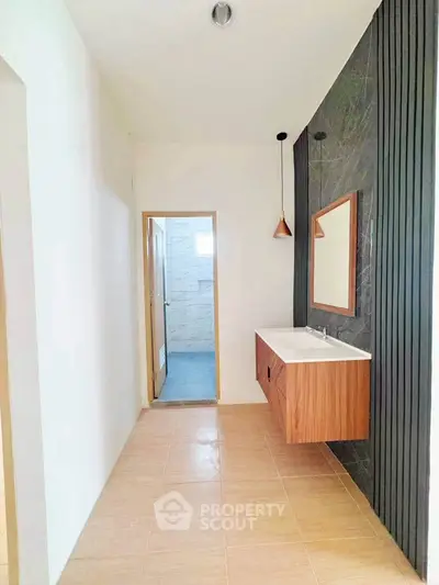 Modern bathroom with sleek wooden vanity and stylish lighting