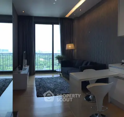 Modern living room with large windows and city view, featuring sleek furniture and stylish decor.