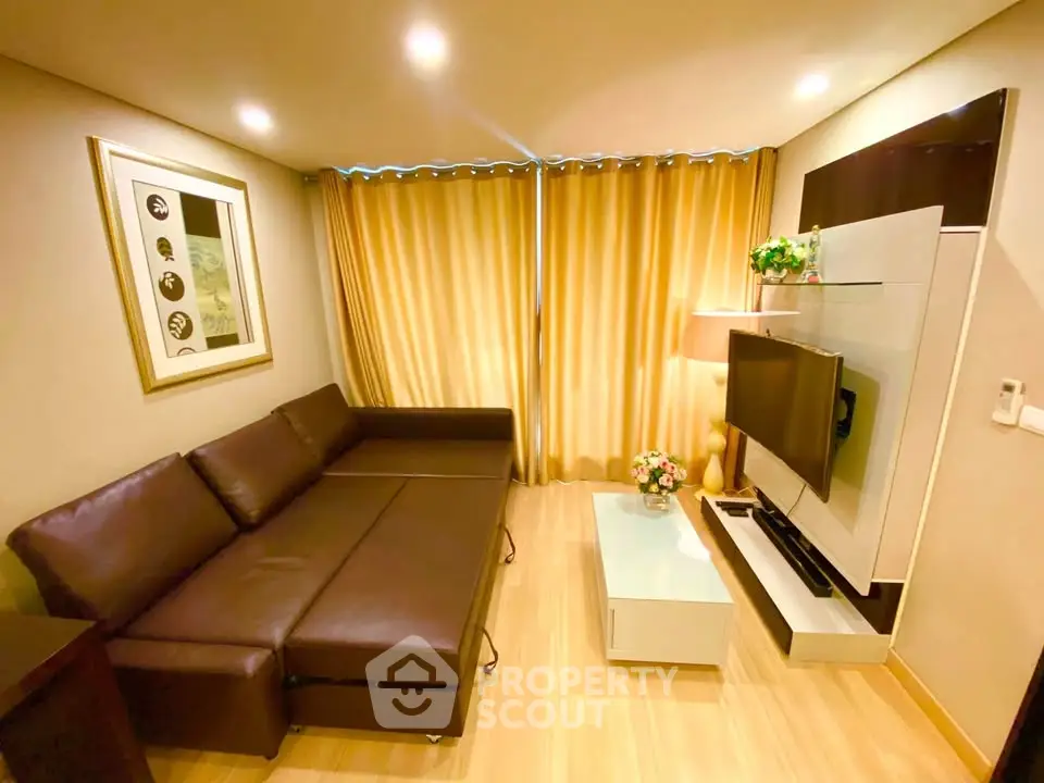 Modern living room with stylish sofa and wall-mounted TV in cozy apartment.