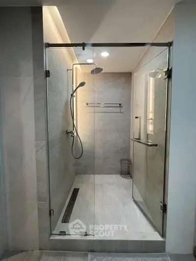 Modern bathroom with glass shower enclosure and sleek fixtures