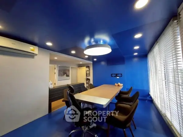 Modern study room with vibrant blue decor and sleek furniture