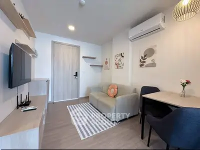 Modern living room with cozy sofa, wall-mounted TV, and stylish decor in a contemporary apartment.