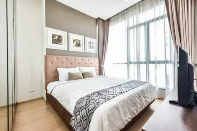 Elegant bedroom with modern decor and large window for natural light