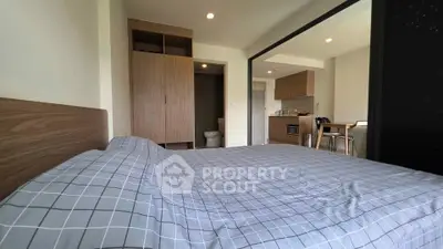 Modern studio apartment with open layout and cozy bedroom area.