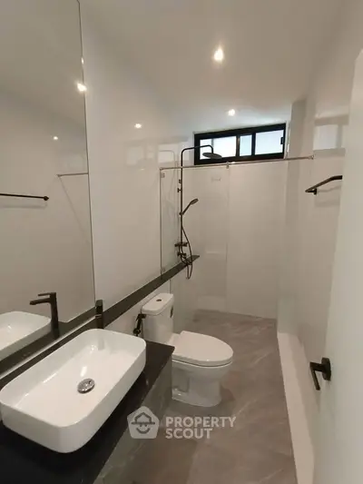 Modern bathroom with sleek fixtures and spacious shower area