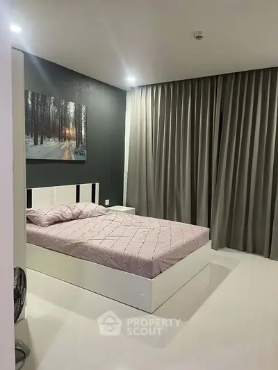 Modern bedroom with sleek design and large window draped with curtains, featuring a stylish bed and wall art.
