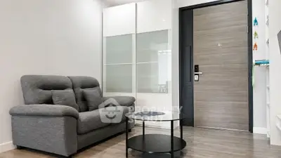 Modern living room with sleek sofa and stylish glass coffee table