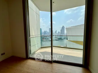 Stunning cityscape view from modern apartment balcony with sleek glass doors.