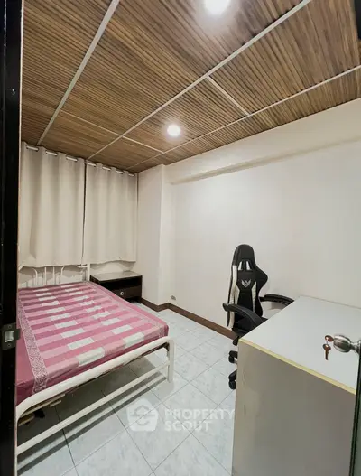Cozy bedroom with modern gaming chair and minimalist decor