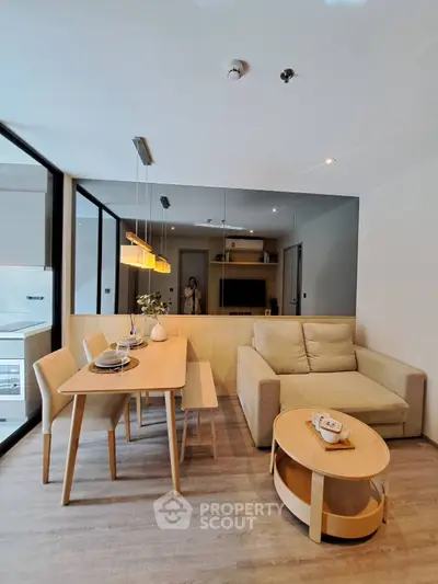 Modern living room with cozy sofa and dining area in open layout apartment
