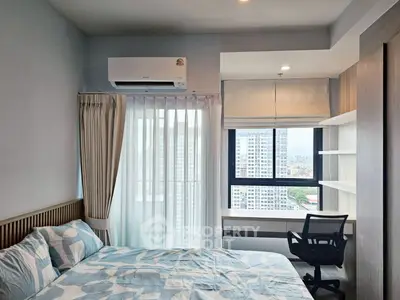 Modern bedroom with city view, featuring stylish decor and ample natural light.