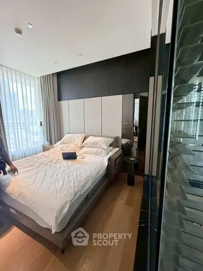 Luxurious bedroom with modern design, large windows, and elegant decor in a high-end apartment.