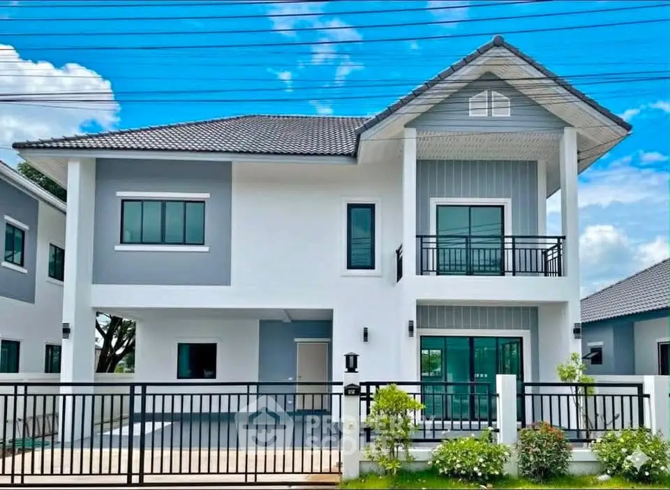 Modern two-story house with sleek design and spacious driveway in a serene neighborhood.