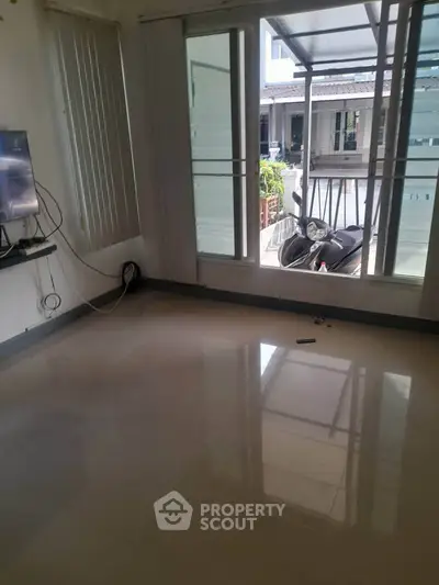 Spacious room with large windows and a view of the driveway, perfect for customization.