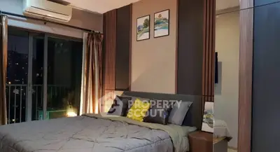 Luxurious bedroom with modern decor and city view balcony, perfect for urban living.