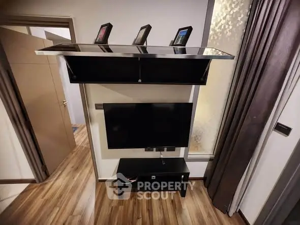 Modern living room with sleek TV setup and wooden flooring