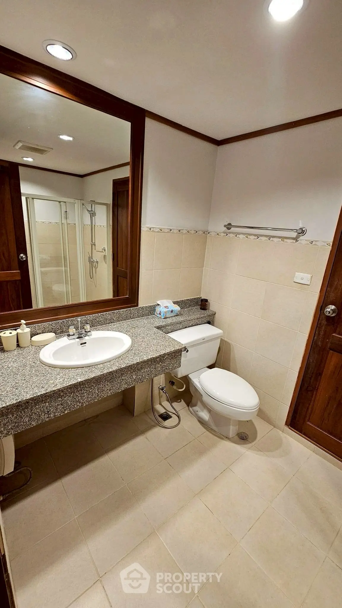 Modern bathroom with granite countertop and glass shower enclosure