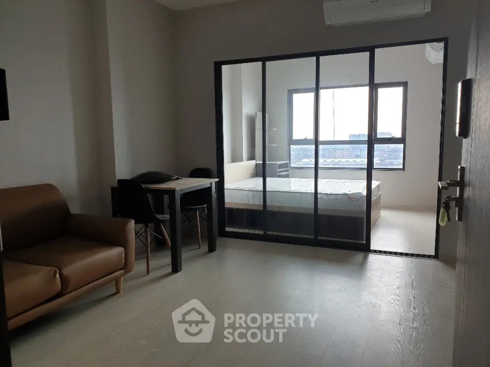 Modern apartment with glass partitioned bedroom and cozy living area