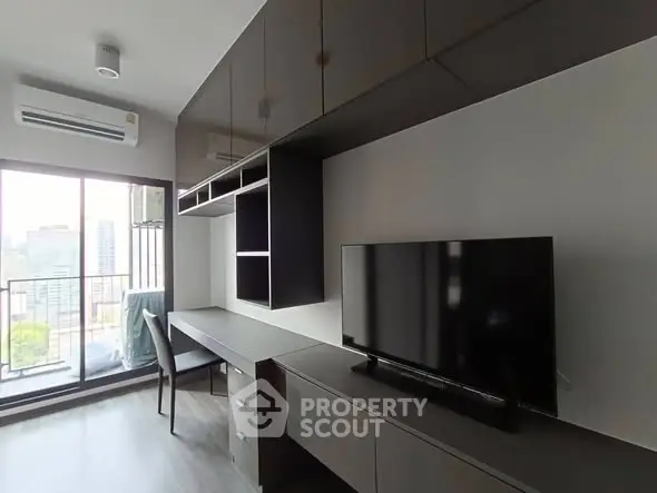 Modern living room with sleek furniture and city view balcony