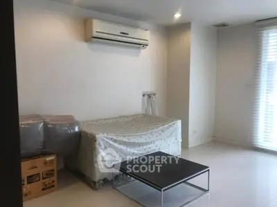 Modern minimalist living room with air conditioning and sleek furniture.
