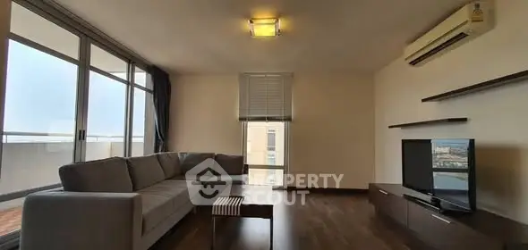 Spacious modern living room with large windows and sleek furniture