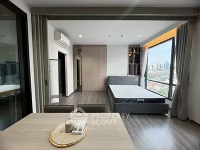 Modern studio apartment with large windows and city view