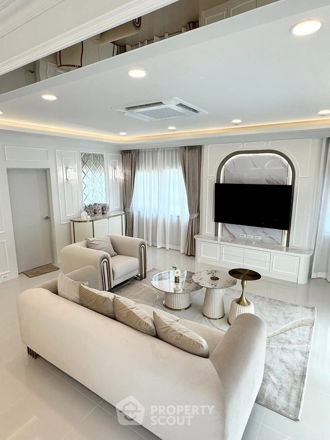 Luxurious living room with elegant furniture and modern decor, featuring a cozy seating area and stylish lighting.
