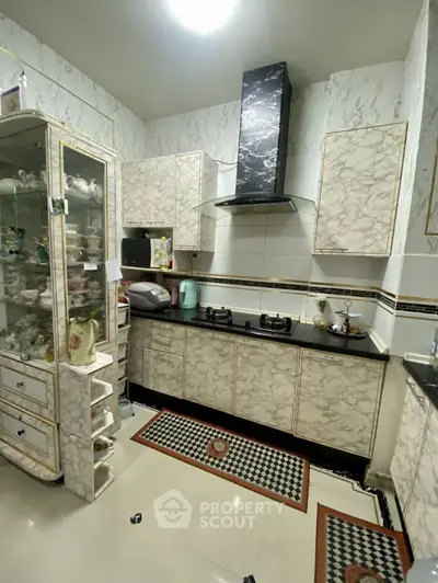 Elegant kitchen with marble finish and modern gas stove