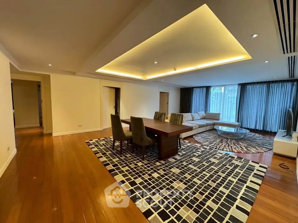 Spacious modern living room with elegant lighting and hardwood floors