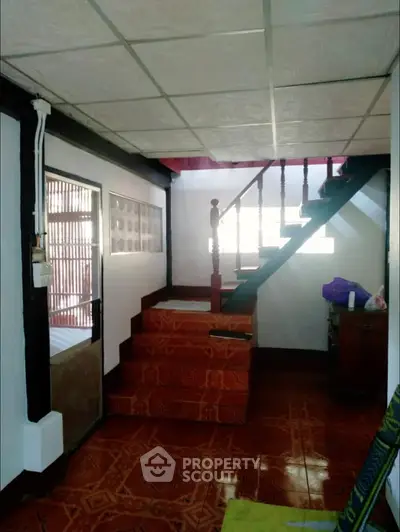 Charming interior with staircase and tiled flooring, perfect for cozy living.