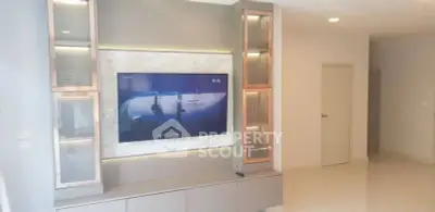 Modern living room with built-in TV unit and sleek design